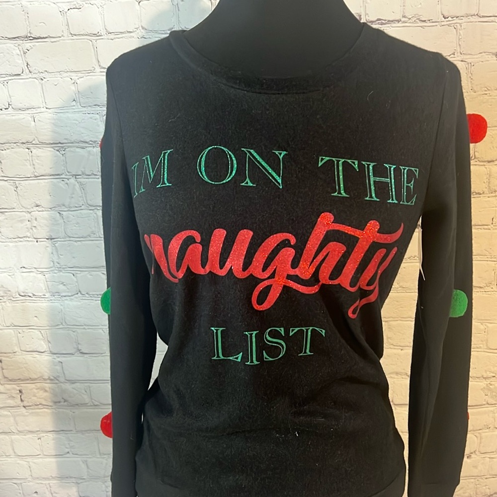 Ugly Christmas Sweater says “I’M ON THE NAUGHTY LIST”. Black knit. Glitter words
